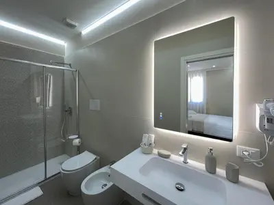 a bathroom with a sink and a toilet and a mirror at Settimo Cielo al Massimo Guest House in Palermo