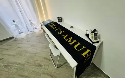 a table with a black and yellow banner on it at That's Amuri in Palermo