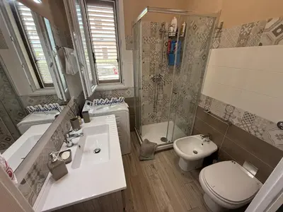 a bathroom with a sink and a toilet and a shower at Villetta Sunrise by Holiday World in Lascari