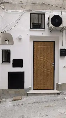 a brown door on the side of a building at Scialari - Palermo Holiday Home in Palermo