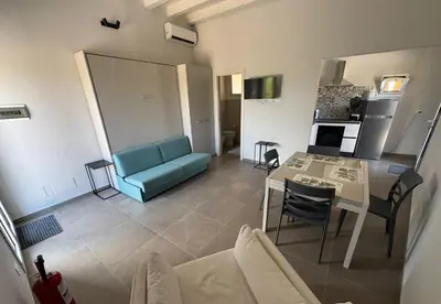 a living room with a blue couch and a table at Case Vacanze Villa Parisi in Bagheria