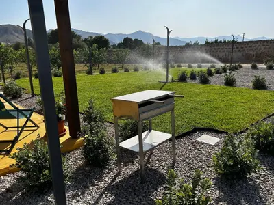 a table in the middle of a garden at Case Vacanze Villa Parisi in Bagheria