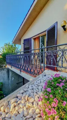 a balcony of a house with pink flowers on it at Domus Dea in Mondello