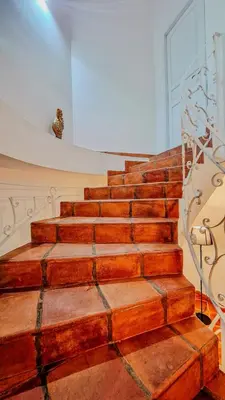 a set of wooden stairs with a metal railing at Domus Dea in Mondello