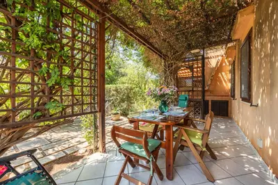 a wooden table and chairs on a patio at Acquamarina 24 in San Vito lo Capo