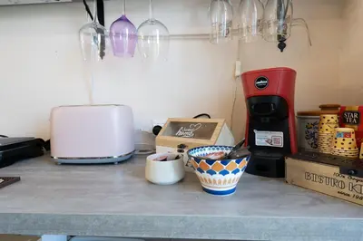 a kitchen counter with a toaster and a coffee maker at Villa a due passi dal mare 