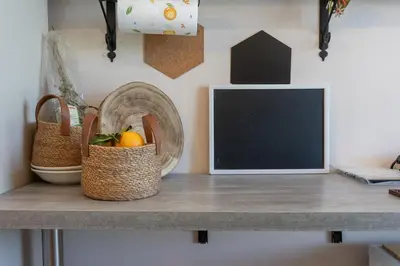 a table with baskets of fruit and a chalkboard at Villa a due passi dal mare 