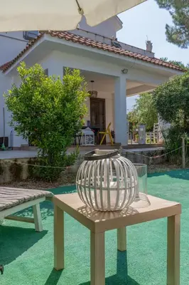 a vase sitting on a table in front of a house at Villa a due passi dal mare 