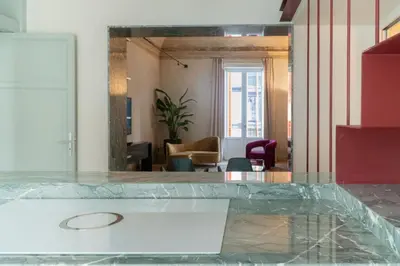 a reflection of a living room in a mirror at Gilded Age Luxury dream apartment historic center in Palermo