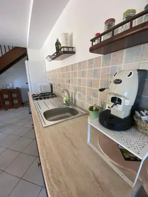a kitchen with a counter top with a panda coffee maker on the counter at Villa Maria in Campofelice di Roccella