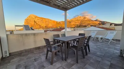 a table and chairs on a balcony with a view at Jecko Apartment in San Vito lo Capo