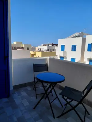 a table and two chairs sitting on a balcony at Jecko Apartment in San Vito lo Capo