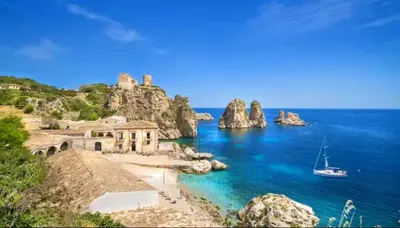 a view of a beach with a boat in the water at Jecko Apartment in San Vito lo Capo