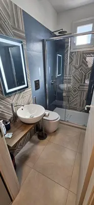 a bathroom with a sink and a toilet and a shower at Jecko Apartment in San Vito lo Capo