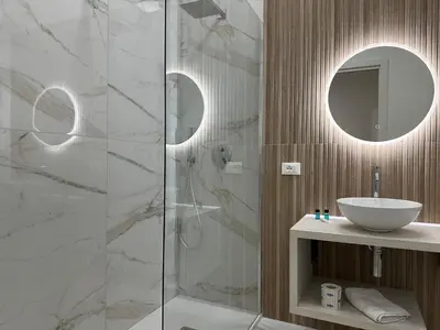 a bathroom with a sink and a shower at BreMi Rooms B&B in San Vito lo Capo