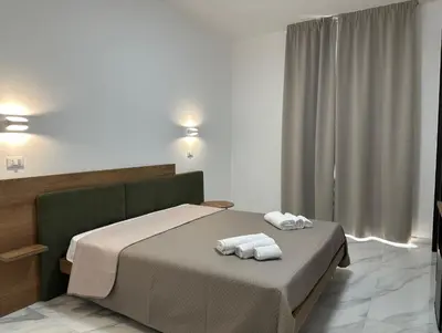 a bedroom with a bed with towels on it at BreMi Rooms B&B in San Vito lo Capo