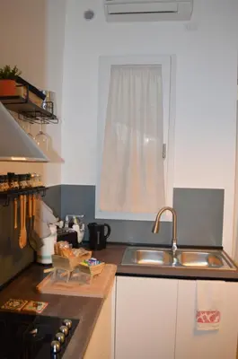 a kitchen with a sink and a stove and a window at Quiet House Palermo in Palermo