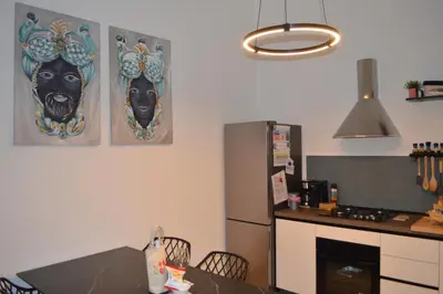 a kitchen with two black masks on the wall at Quiet House Palermo in Palermo