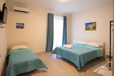 a bedroom with two beds and a window at Bivio 281 suite&rooms in Carini
