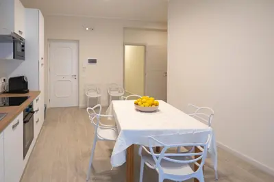 a kitchen with a table with a bowl of fruit on it at Bivio 281 suite&rooms in Carini