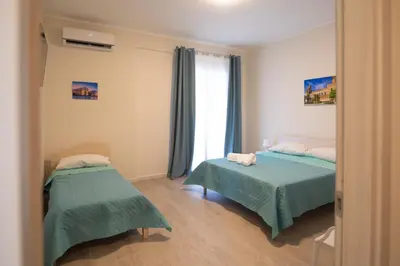 a bedroom with two beds and a window at Bivio 281 suite&rooms in Carini