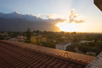 a view of the sunset from the roof of a building at Bivio 281 suite&rooms in Carini