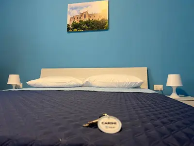 a bedroom with a bed with a clock on it at Bivio 281 suite&rooms in Carini