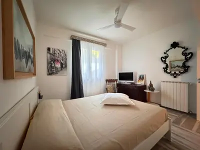 a bedroom with a large bed and a television at Amunì Guest House in Carini