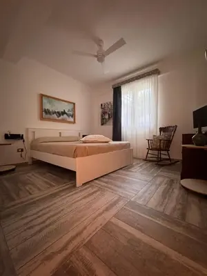 a bedroom with a large bed and a window at Amunì Guest House in Carini