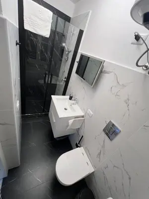 a bathroom with a toilet and a sink and a shower at Appartamenti Tiffany & Timi in Carini