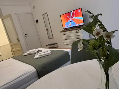 a bedroom with a bed and a tv on a dresser at Appartamenti Tiffany & Timi in Carini