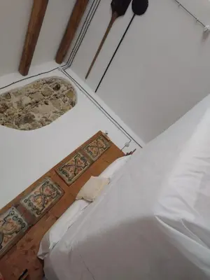a bedroom with a white bed and a ceiling at Antica Dimora Vaglica in Palermo