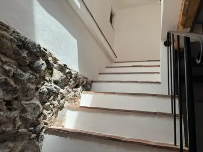 a set of stairs next to a stone wall at Antica Dimora Vaglica in Palermo