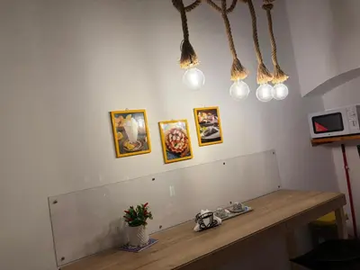 a table in a room with pictures on the wall at Al Duomo apartment in Palermo in Palermo