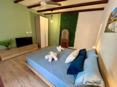 two stuffed animals sitting on a blue bed in a room at Al Duomo apartment in Palermo in Palermo