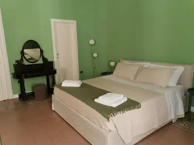 a bedroom with a bed with a mirror and a piano at Le case di Giù in Palermo