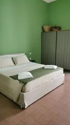 a bedroom with a large bed with two towels on it at Le case di Giù in Palermo