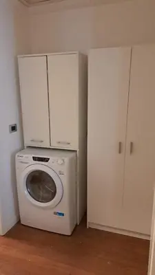 a laundry room with a washing machine and cabinets at Le case di Giù in Palermo