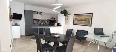 a dining room and kitchen with a table and chairs at Ottolune Accomodations in Campofelice di Roccella