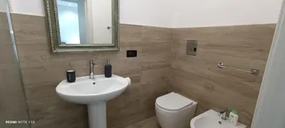 a bathroom with a sink and a toilet and a mirror at Ottolune Accomodations in Campofelice di Roccella