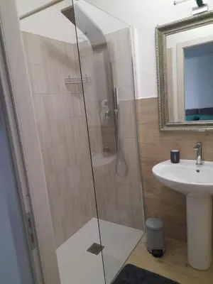 a bathroom with a shower and a sink at Ottolune Accomodations in Campofelice di Roccella