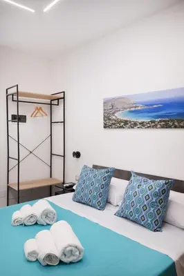 a bedroom with a bed with towels on it at Matrice Rooms in Palermo