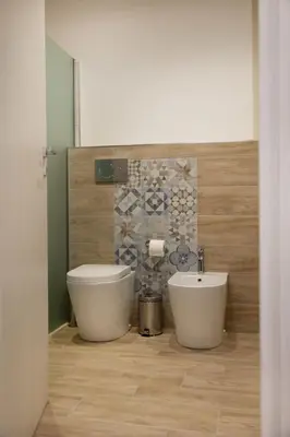 a bathroom with a toilet and a sink at Matrice Rooms in Palermo