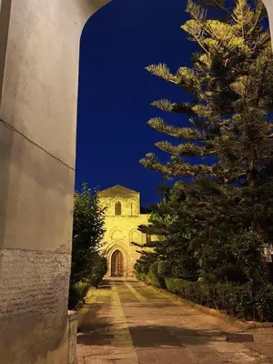 a building with a tree on the side of a road at Casuzza del genio in Palermo