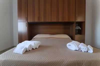 a bedroom with two towels on a bed at Twins House Vacation Home in Carini