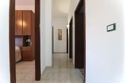 a hallway of a hotel room with a bedroom at Twins House Vacation Home in Carini
