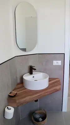 a bathroom with a sink and a mirror at Villa Zagara modern villa with pool in Lascari