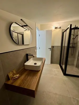 a bathroom with a white sink and a mirror at Villa Zagara modern villa with pool in Lascari