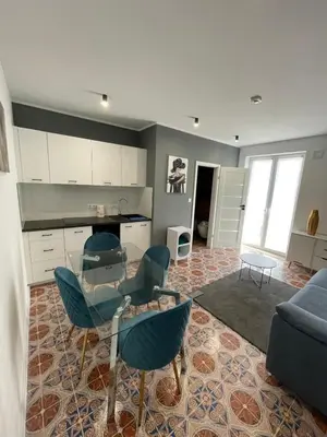 a living room with a blue couch and chairs at Vento di Sicilia in Carini