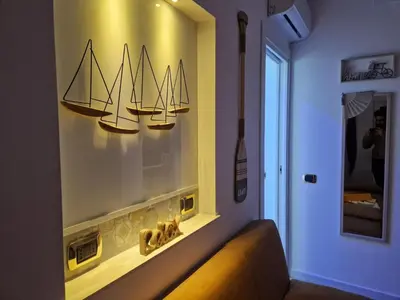 a room with a shelf with three model boats on the wall at Da poppa a prua in Palermo